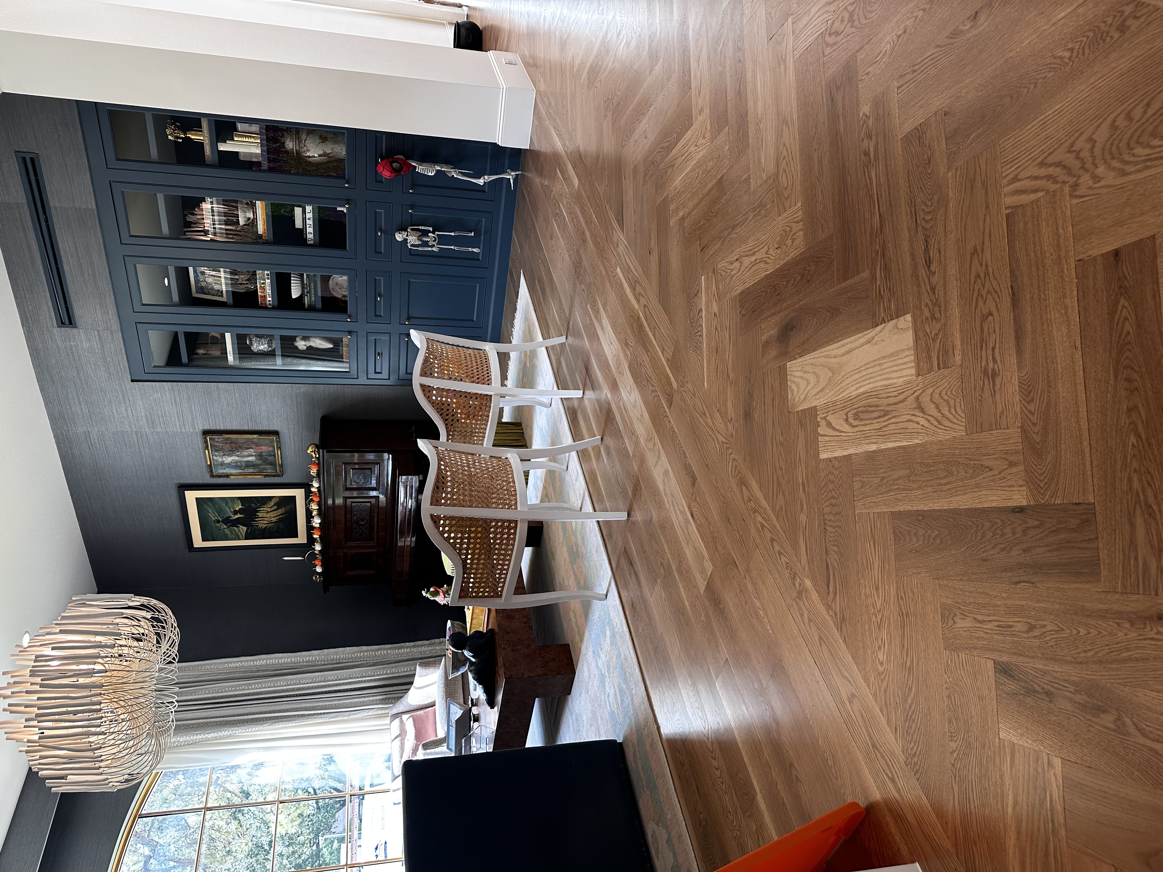 Furnished living room with herringbone white oak hardwood floors